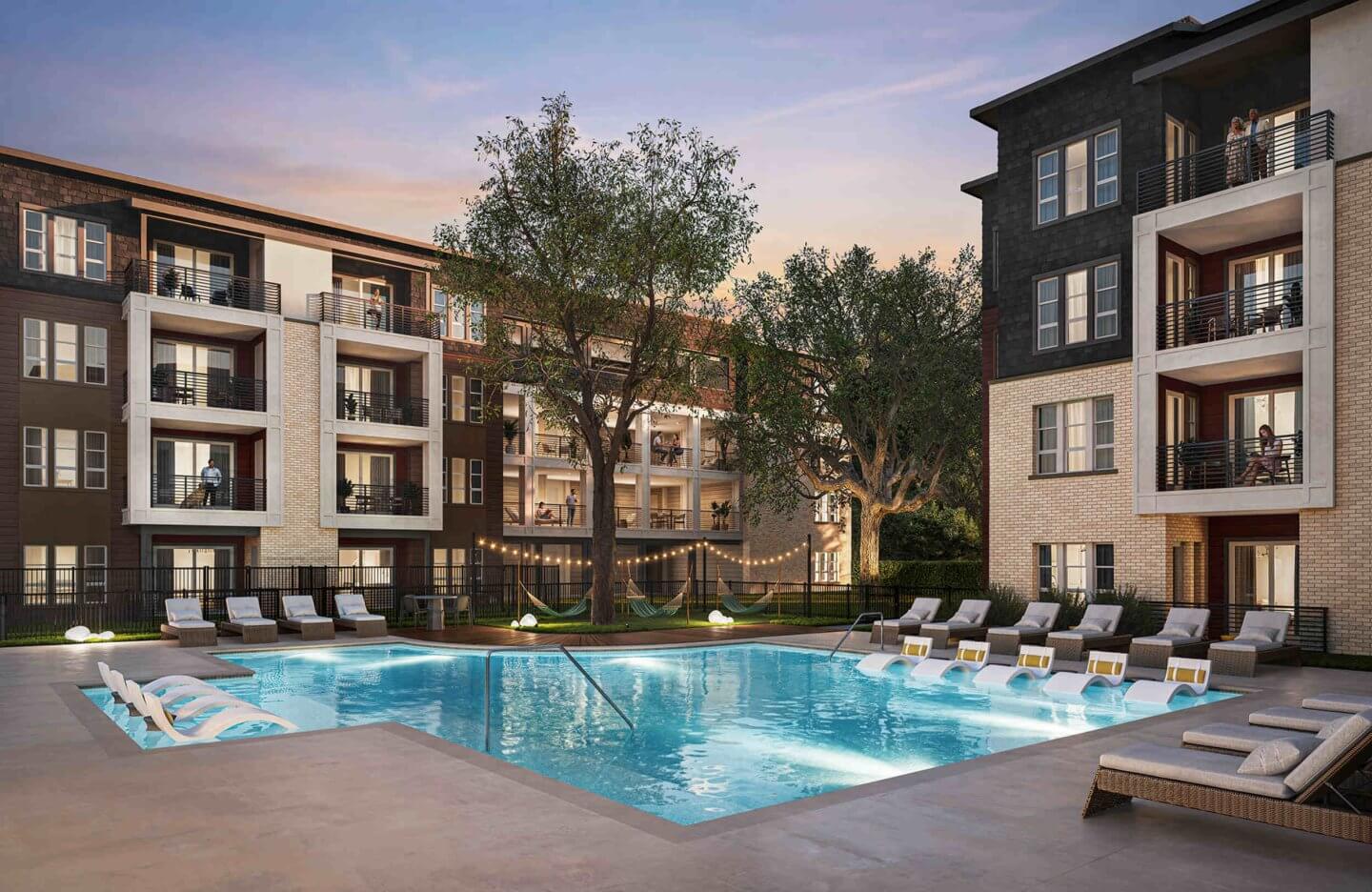 The peaceful resort pool at Otto on the Trail at dusk, with ambient lighting creating a warm and relaxing escape for residents.